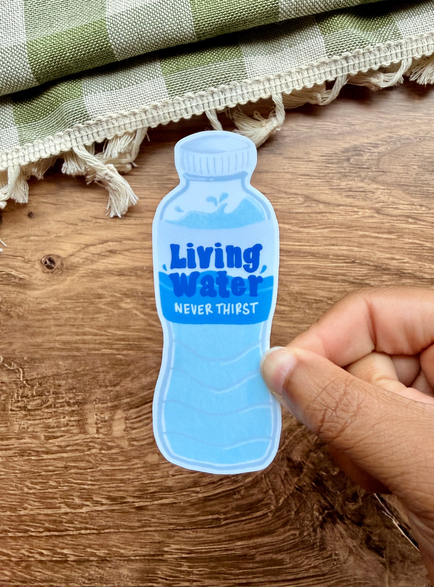 Living Water sticker in blue, shaped like a water bottle with "NEVER THIRST" text.