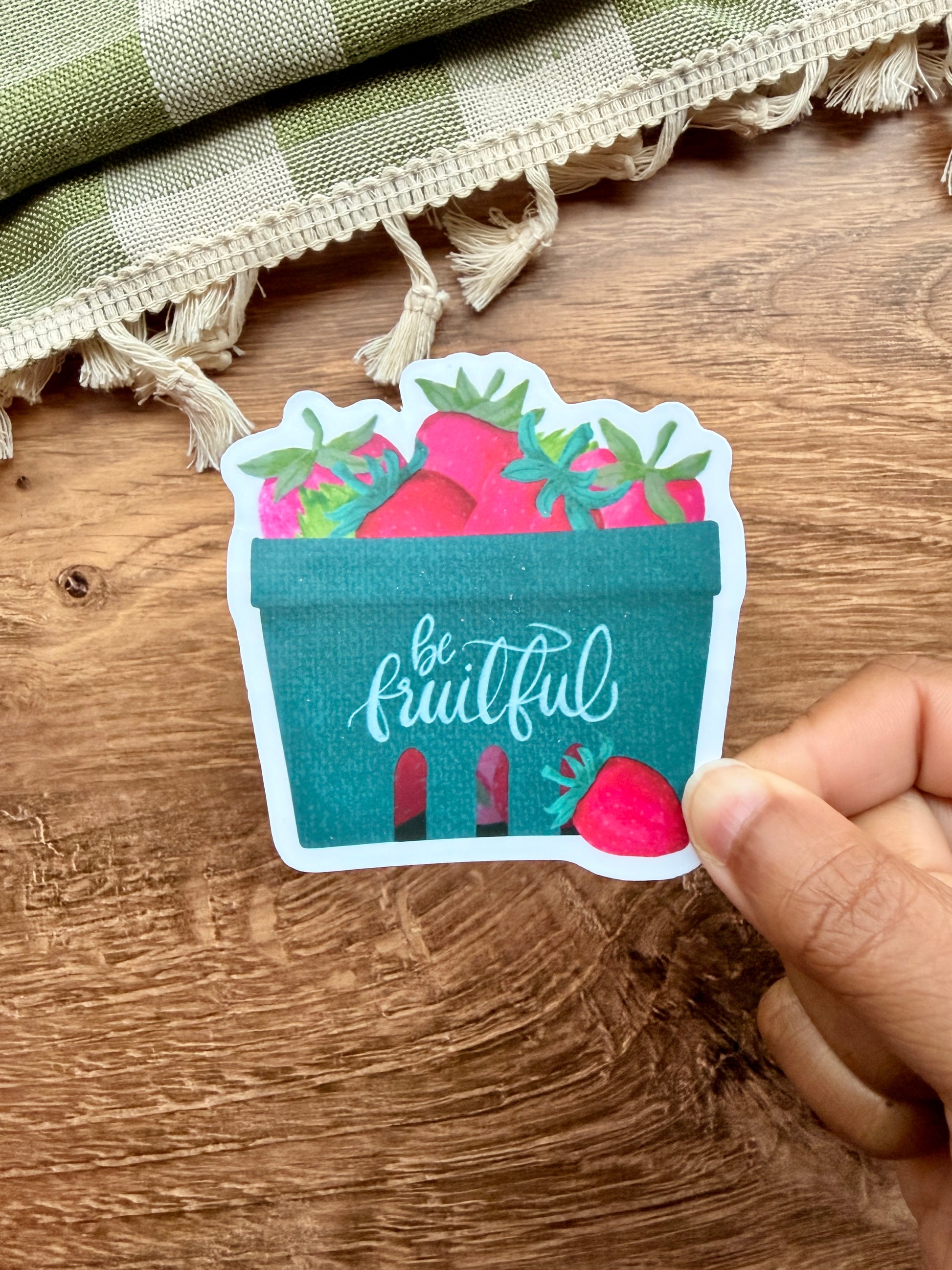 Be Fruitful Strawberry Basket Sticker featuring a teal basket filled with vibrant strawberries.